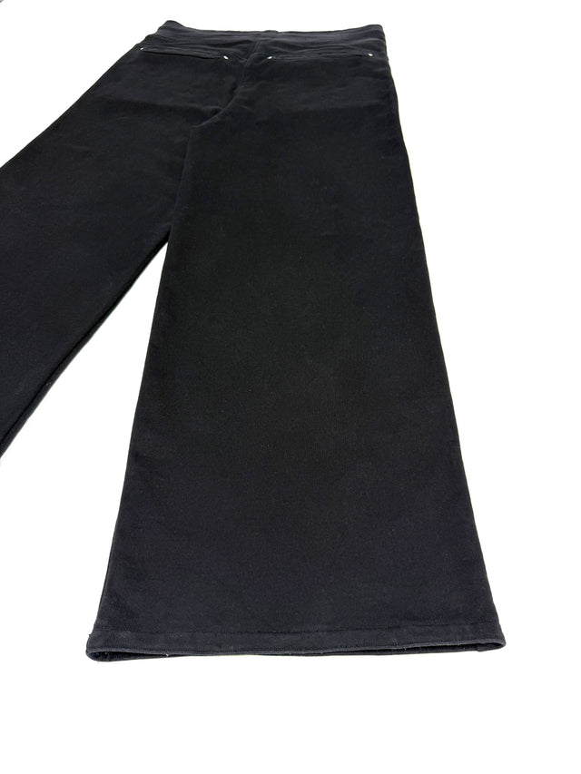 Close-up of the LOVANT black sweats, showing the wide leg and stitched hem.