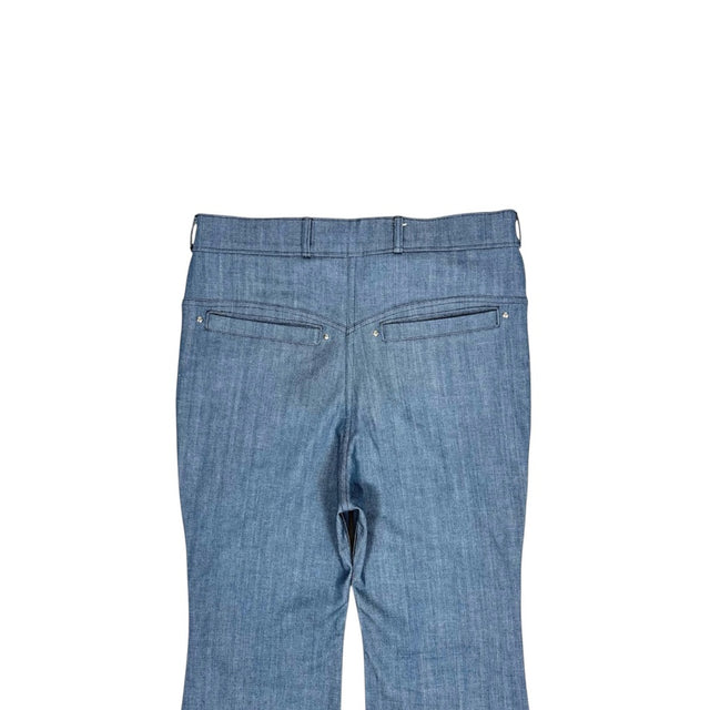 Close-up of the back of the LOVANT blue UNIFORM flared denim, showing the back pocket openings, rivets and belt loops.