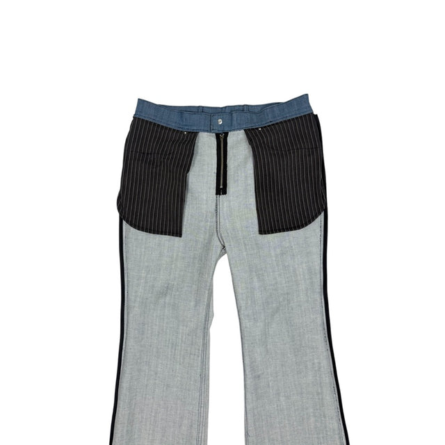 Close-up of the inside of the LOVANT blue UNIFORM flared denim, showing the pinstripe pocket bags and zip fly construction.