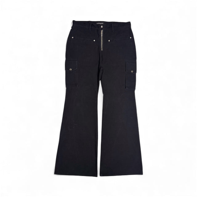 Front view of the LOVANT Apocalypse flared denim in black, laid flat, showing an exposed silver zip fly, snap-button welt pockets and side cargo pockets.