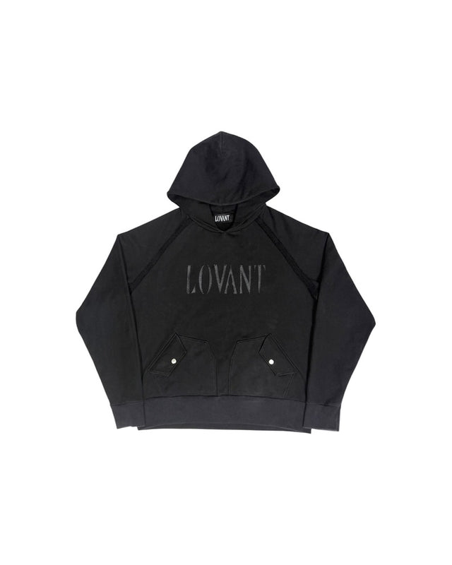 Front view of the LOVANT black raglan hoodie, laid flat, showing the tonal leather LOVANT wordmark and snap-flap front pockets.