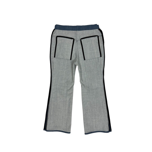 Back of the LOVANT blue UNIFORM flared denim turned inside out, showing the black bound seams and pocket construction.