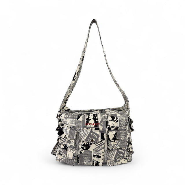 Front view of the LOVANT Jornal utility cargo bag in a black-and-white newspaper-collage print, showing red LOVANT embroidery and rows of snap-flap pockets.