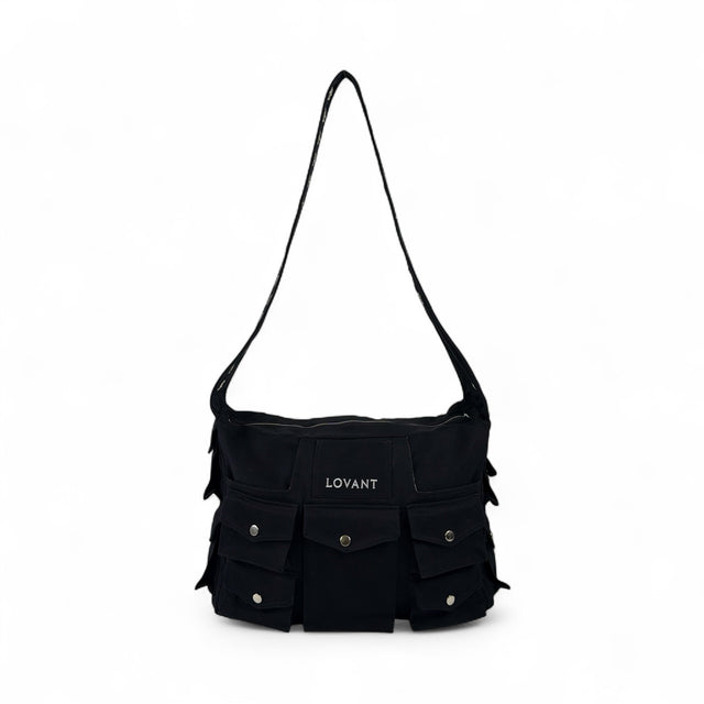 Front view of the LOVANT Preta utility cargo bag in black, showing the embroidered LOVANT patch and rows of snap-flap cargo pockets.