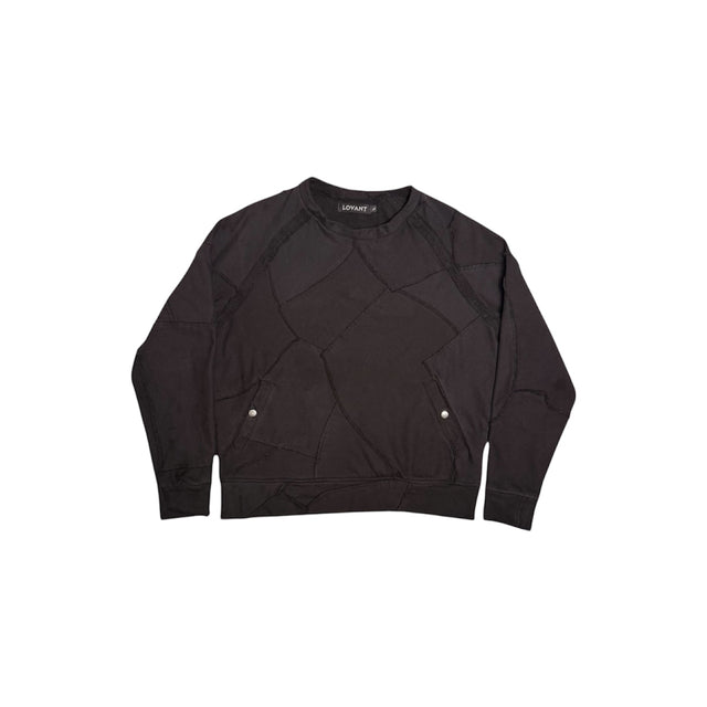 Front view of the LOVANT Rose From The Dead crewneck in black, laid flat, showing raw-edge patchwork panels and two snap-button side pockets.