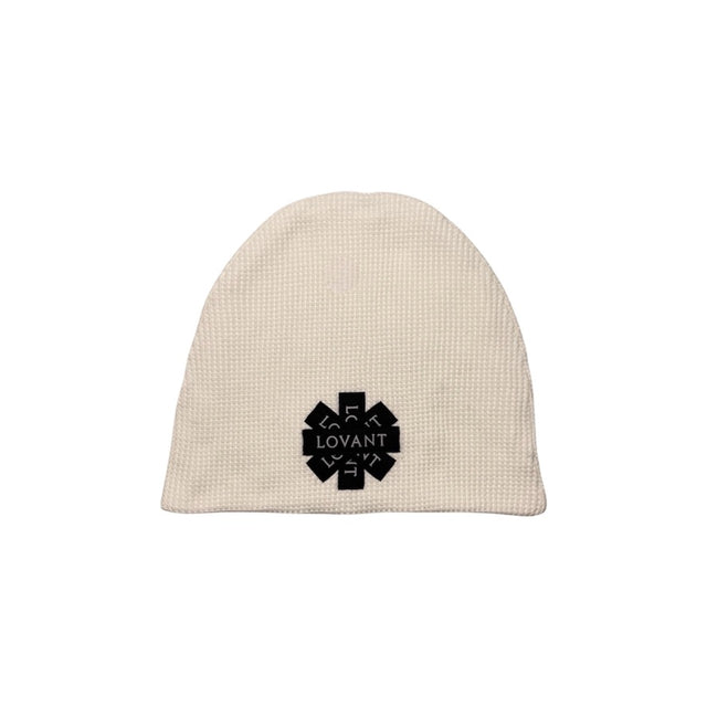 Front view of the LOVANT waffle knit beanie in cream, laid flat, showing the black star-shaped emblem patch made of layered LOVANT labels.